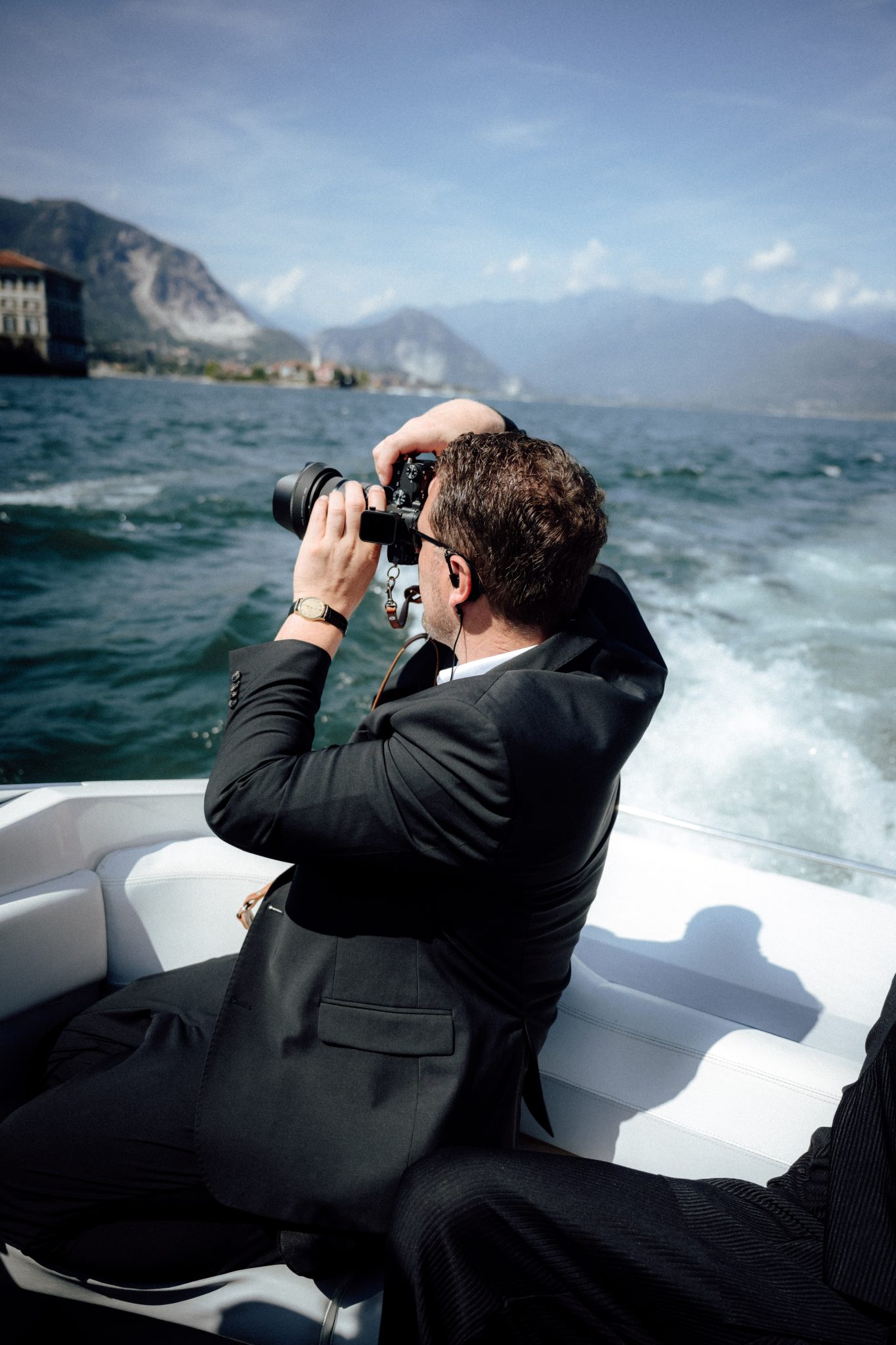 Dennis Brandt photographing from a boat on Lake Como during a destination wedding