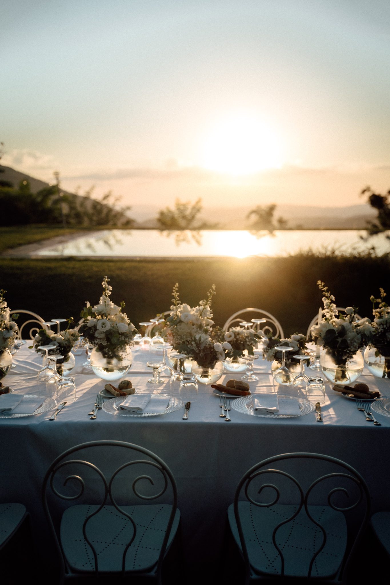 Long wedding dinner table at sunset above the Umbrian hills, Le Silve di Armenzano