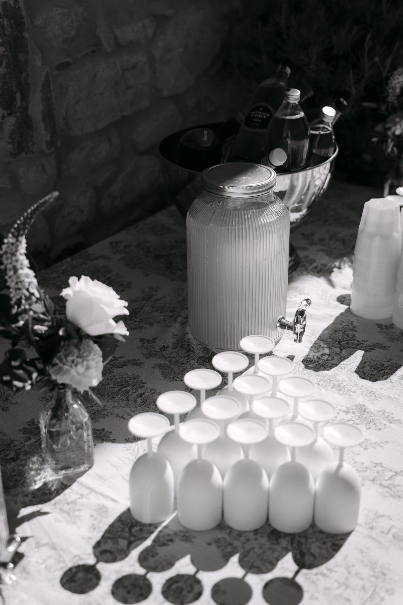 Welcome drinks table with white glasses in the sun, black and white
