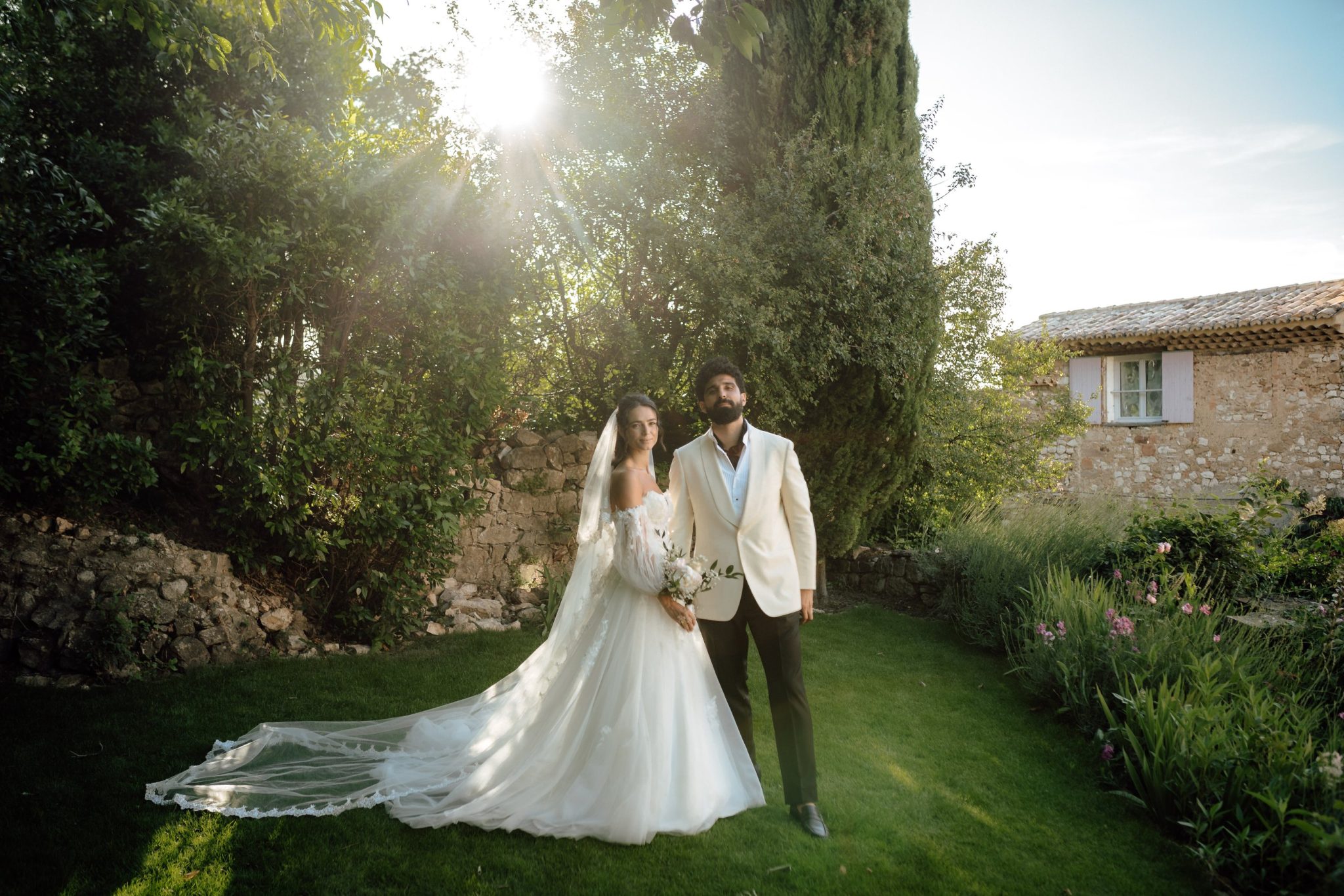 Bride and groom in the chateau garden in warm evening sun, Provence
