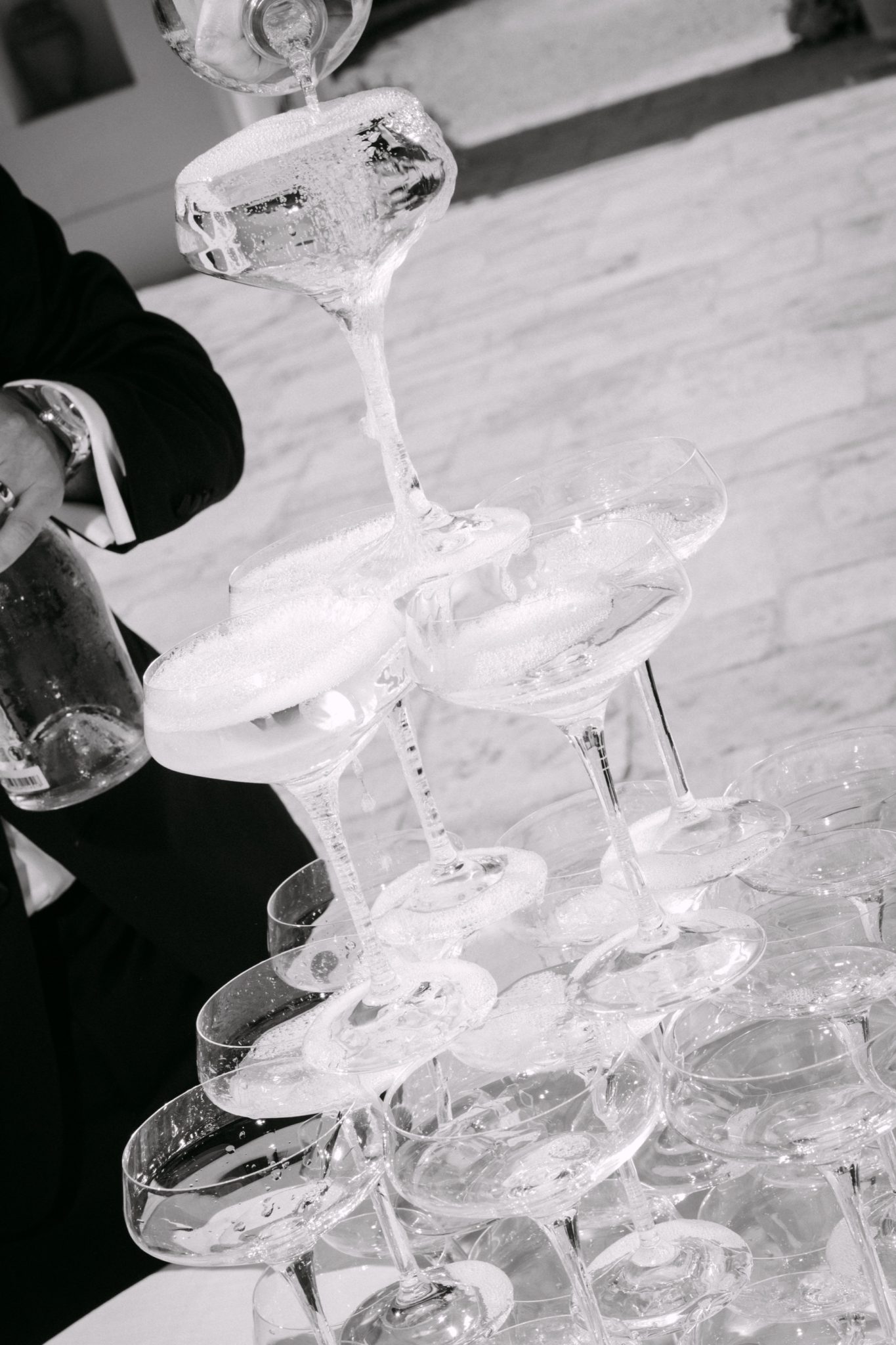 Black and white champagne tower being poured